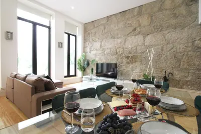 a living room with a table with wine glasses at Porto Unique Downtown Garden in Porto
