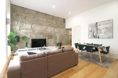 a living room with a couch and a dining room at Porto Unique Downtown Garden in Porto
