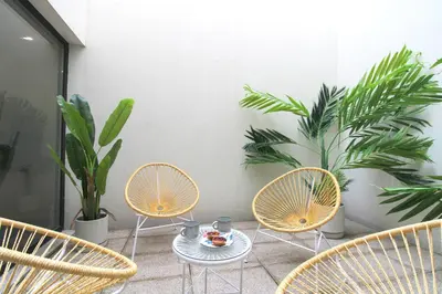 a patio with chairs and a table and plants at Porto Unique Downtown Garden in Porto