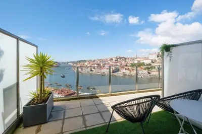 a balcony with chairs and a view of the water at GuestReady - Port Studio 3 in Vila Nova de Gaia