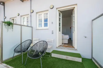 a patio with two chairs and a house at GuestReady - Port Studio 3 in Vila Nova de Gaia