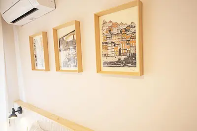 four framed pictures on a wall in a room at CityLiving in Porto