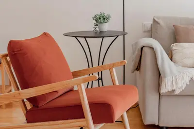 a chair and a table in a living room at Virtudes Flat w/ AC & Balcony by LovelyStay in Porto
