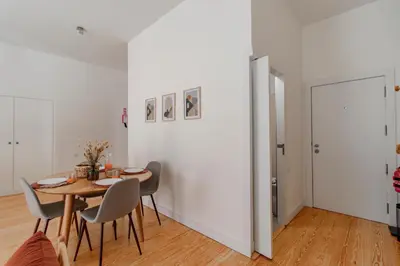 a dining room with a table and chairs at Virtudes Flat w/ AC & Balcony by LovelyStay in Porto