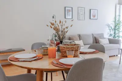 a dining room table with plates and drinks on it at Virtudes Flat w/ AC & Balcony by LovelyStay in Porto