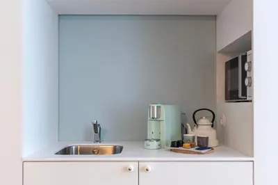 a kitchen counter with a sink and a mixer at Blau 1911 in Porto