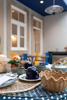 a table with plates and baskets on top of it at Blau 1911 in Porto