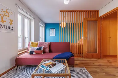 a bedroom with a blue wall and a bed at A Pop of Color by LovelyStay in Porto