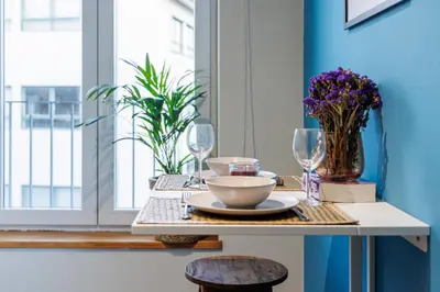 a living room with a couch and a table at A Pop of Color by LovelyStay in Porto