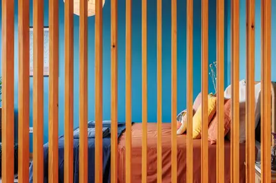 a room with a wooden partition with a bed in it at A Pop of Color by LovelyStay in Porto