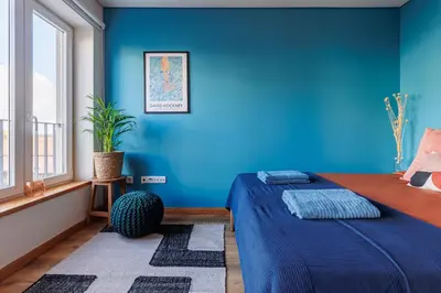 a blue bedroom with a bed and a blue wall at A Pop of Color by LovelyStay in Porto