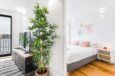 a bedroom with a bed and a potted plant at Sunshine Luxury House Urban Retreat Downtown Porto in Porto