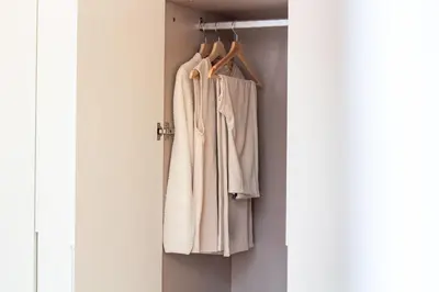 a closet with white clothes hanging on a door at Mouzinho da Silveira 215 by LovelyStay in Porto