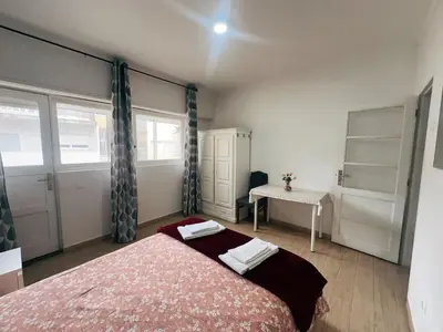 a bedroom with a bed and a table in it at Ap Centro de Gaia in Vila Nova de Gaia
