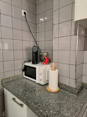 a microwave sitting on a counter in a kitchen at Ap Centro de Gaia in Vila Nova de Gaia