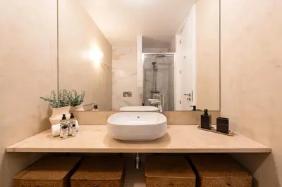 a room with a mirror and a table with a mirror at Modern Charming Loft with balcony in central Porto by Lisbeyond in Porto