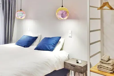 a bedroom with two beds and blue pillows at Two Bedroom Terrace Sanctuary in the Center in Porto