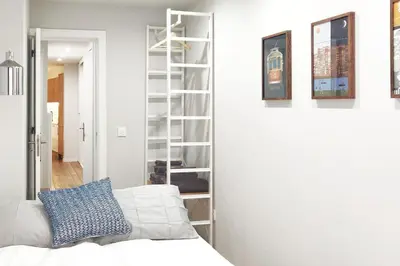 a room with a bed and a book shelf at Two Bedroom Terrace Sanctuary in the Center in Porto