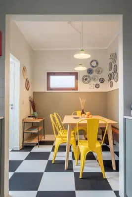 a dining room with a table and yellow chairs at Trendy and Modern 3BR Family Home in Porto