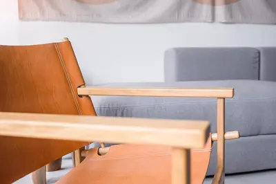 a chair and a blue couch in a room at GuestReady - The Modern Silveira in Porto