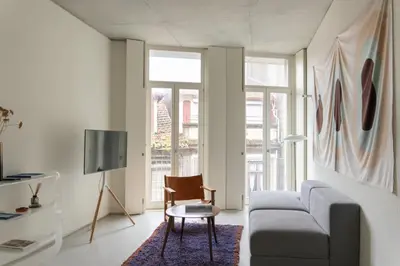 a living room with a couch and a chair at GuestReady - The Modern Silveira in Porto