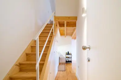 a staircase in a house with wooden floors and a door at PortoDise Loft by RDC in Porto