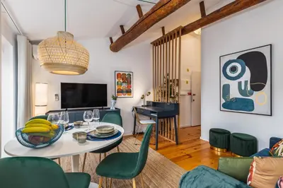 a living room with a table and green chairs at OPO Vale Formoso I in Porto