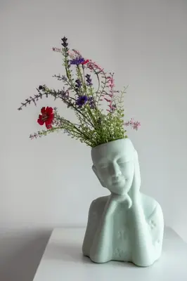 a white statue with a vase filled with flowers at OPO Vale Formoso I in Porto