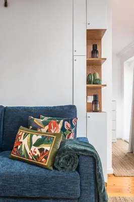 a blue couch with a pillow on it in a living room at OPO Vale Formoso I in Porto