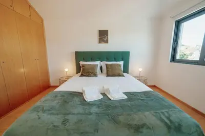 a bedroom with a large bed with two pillows at Modern & Stylish Apartments by Vacationy in Porto
