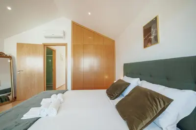 a bedroom with a large white bed with towels on it at Modern & Stylish Apartments by Vacationy in Porto