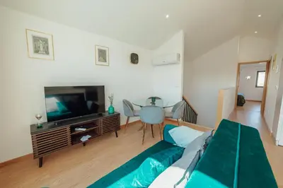 a living room with a couch and a television at Modern & Stylish Apartments by Vacationy in Porto