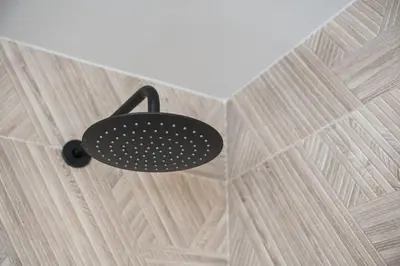 a shower with a black object on the ceiling at GuestReady - Blue shades with panoramic city views in Porto