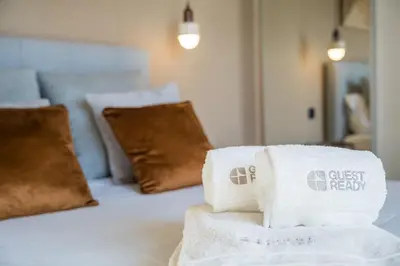 a pile of towels sitting on top of a bed at GuestReady - Blue shades with panoramic city views in Porto