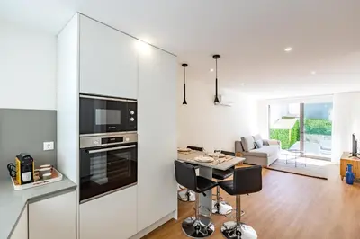 a kitchen and living room with a table and chairs at Pestana Apartments - Premium in Porto