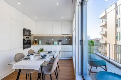 a kitchen and dining room with a table and chairs at Pestana Apartments - Premium in Porto
