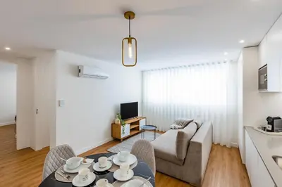 a living room with a couch and a table at Pestana Apartments - In city center, Modern, New and Cozy in Porto
