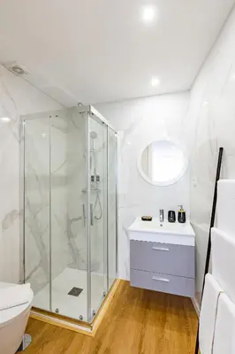 a white bathroom with a shower and a toilet at Pestana Apartments - In city center, Modern, New and Cozy in Porto