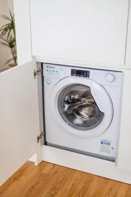 a washer and dryer in a white room at Pestana Apartments - In city center, Modern, New and Cozy in Porto