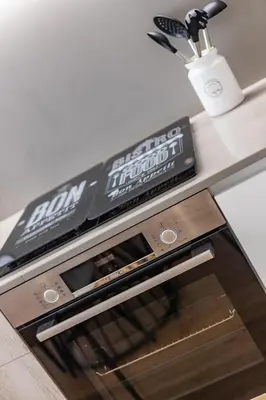 a pizza box sitting on top of an oven at Pestana Apartments - In city center, Modern, New and Cozy in Porto