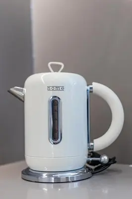 a white kettle sitting on top of a counter at Pestana Apartments - In city center, Modern, New and Cozy in Porto