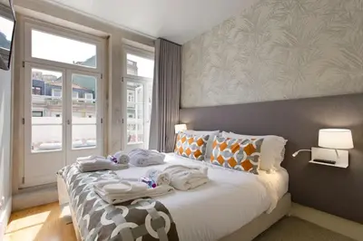 a bedroom with a bed with towels on it at BOUTIQUE Rentals- P*O*R*T*O Ribeira in Porto