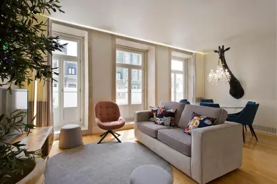 a living room with a couch and a chair at BOUTIQUE Rentals- P*O*R*T*O Ribeira in Porto