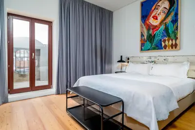 a bedroom with a large white bed and a window at Limehome Porto Rua Das Oliveiras in Porto