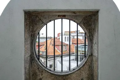 a window in a building with a view of buildings at Limehome Porto Rua Das Oliveiras in Porto