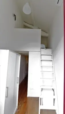 a room with white bunk beds and a ladder at Rustic Silent Ensuites - Shared Kitchen - Self check in in Porto