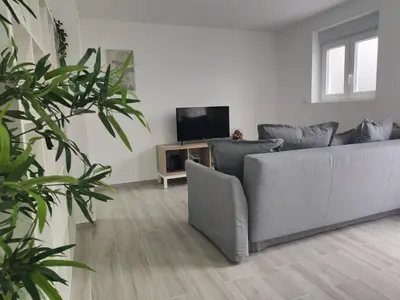 a living room with a couch and a television at Casa Mini-Ventuzelo by JC in Porto