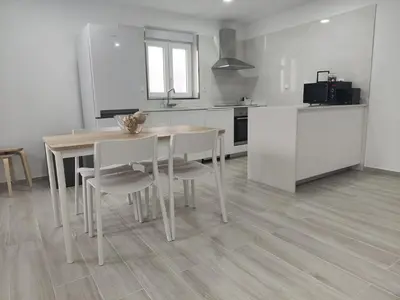 a kitchen with a table and chairs in a room at Casa Mini-Ventuzelo by JC in Porto