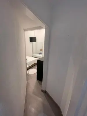 a hallway with a room with a bed and a mirror at Guesthouse Franco in Porto