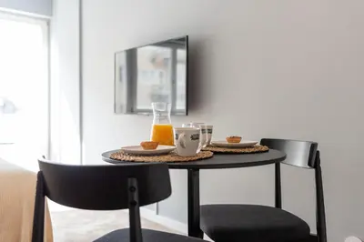 a small table with food and orange juice on it at Ceuta 70 by LovelyStay in Porto